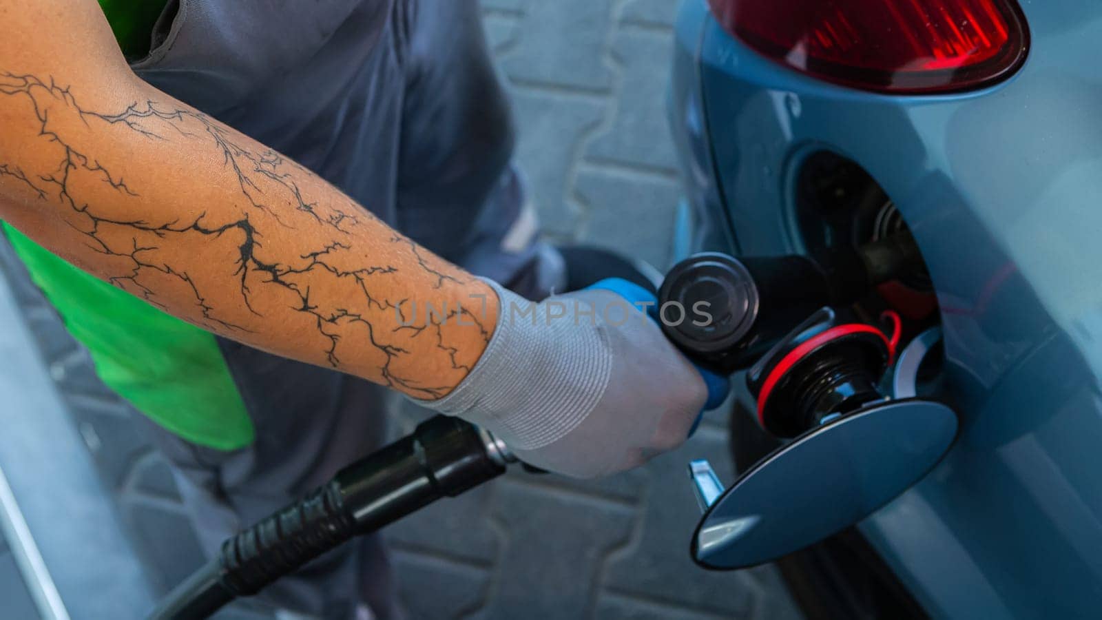 Hand Man Refill and filling Oil Gas Fuel at station. Gun petrol in the tank to fill. Pumping gasoline fuel in car at gas station. Refueling automobile with gasoline or diesel with a fuel dispenser.