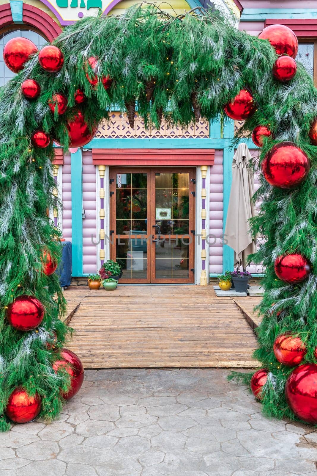 the entrance of the hotel bar restaurant is decorated with Christmas balls. photo