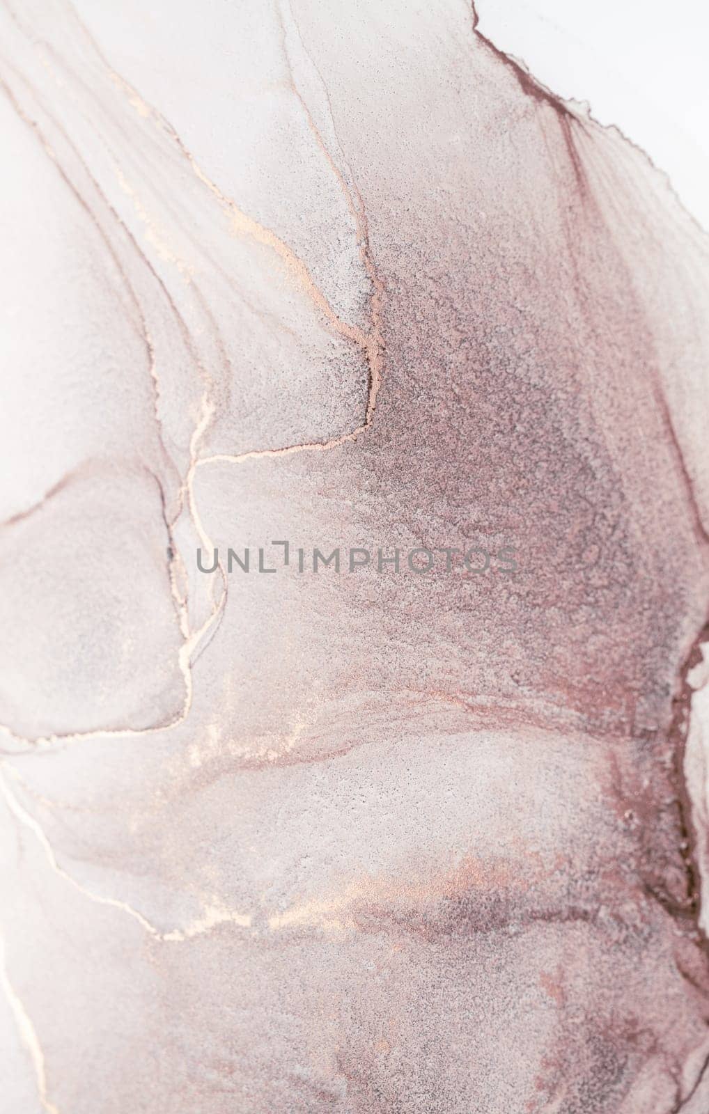 A close-up abstract painting featuring pink and gold hues, showcasing the flowing and swirling patterns of watercolor paint.