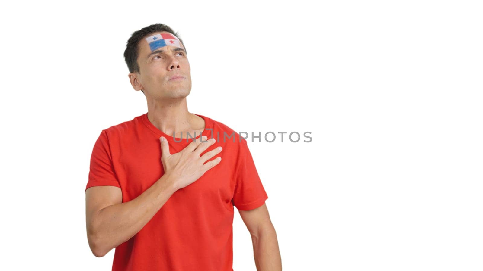 Photo of man listening to the Panama national anthem with solemnity