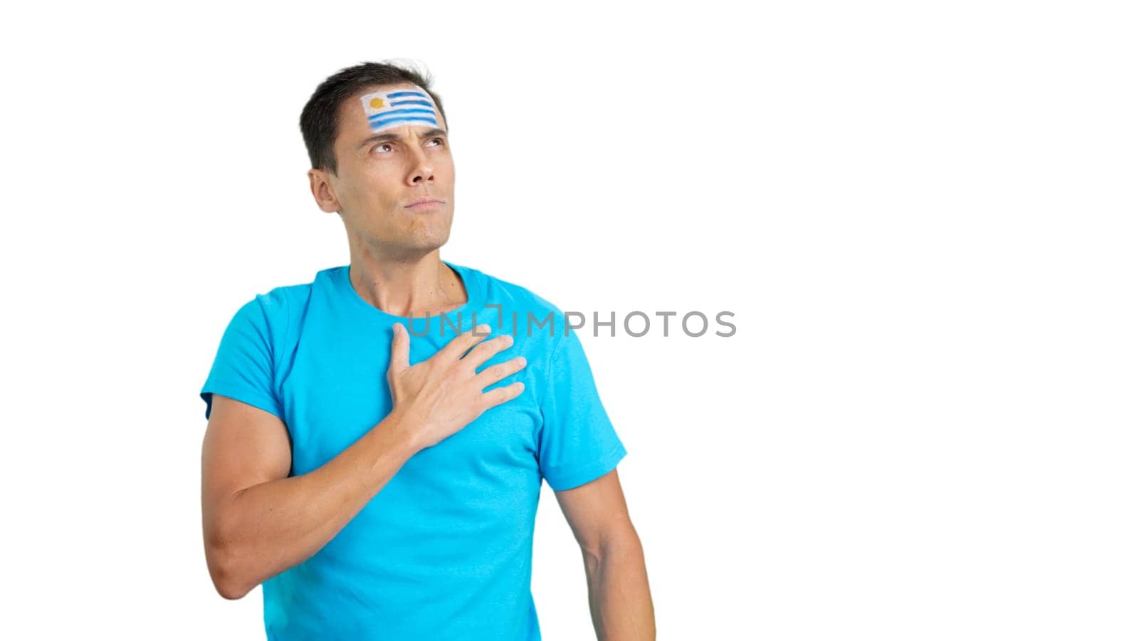 Photo of Man listening to the Uruguay national anthem with solemnity