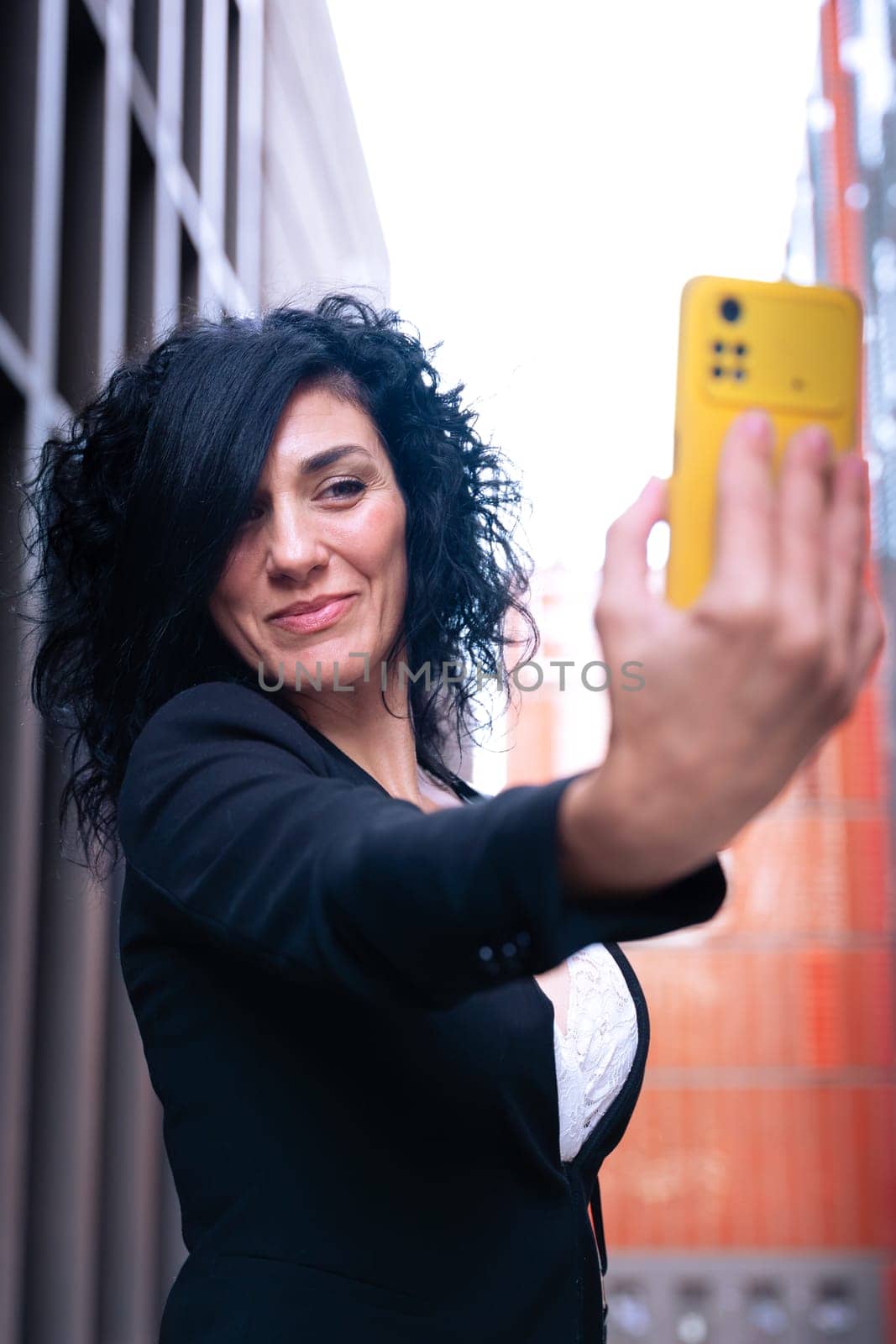 Happy young woman taking a selfie with smartphone.Vertical