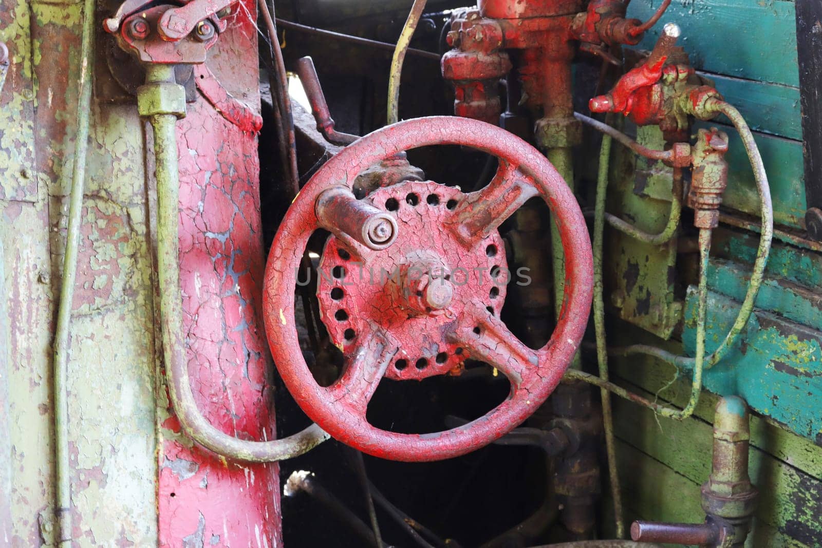 Steam engine controls. Fragment of the driver's cabin of a retro steam locomotive with steam engine controls, taps, valves, pipes, controls...