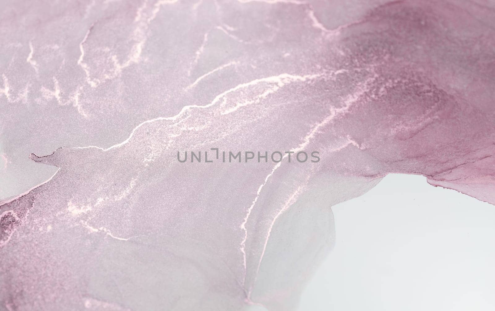 A close-up image of a pink and rose gold abstract design, with swirling patterns.
