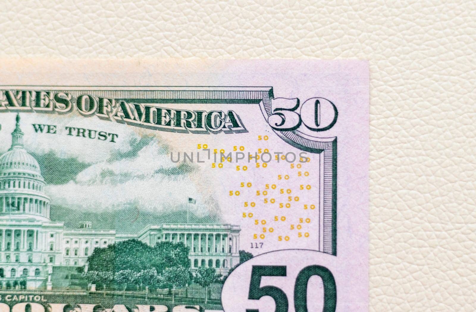 Close up shot of the US dollars note bill on the white leather background