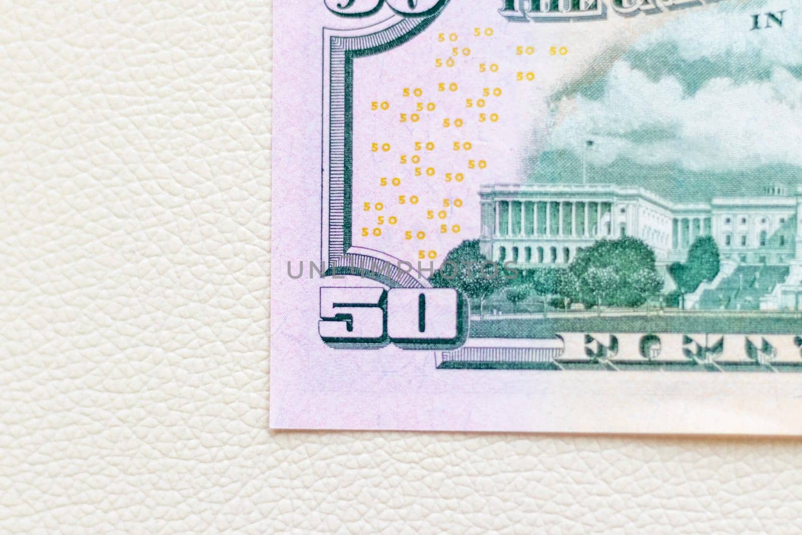 Close up shot of the US dollars note bill on the white leather background