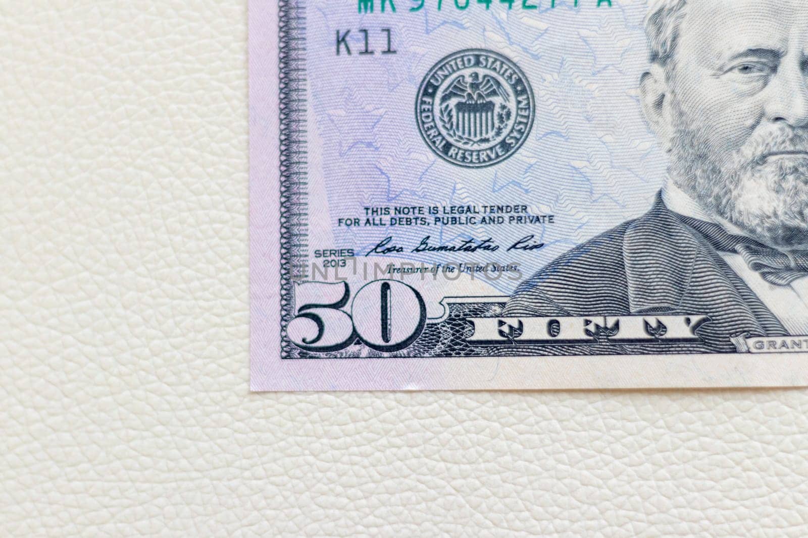 Close up shot of the US dollars note bill on the white leather background