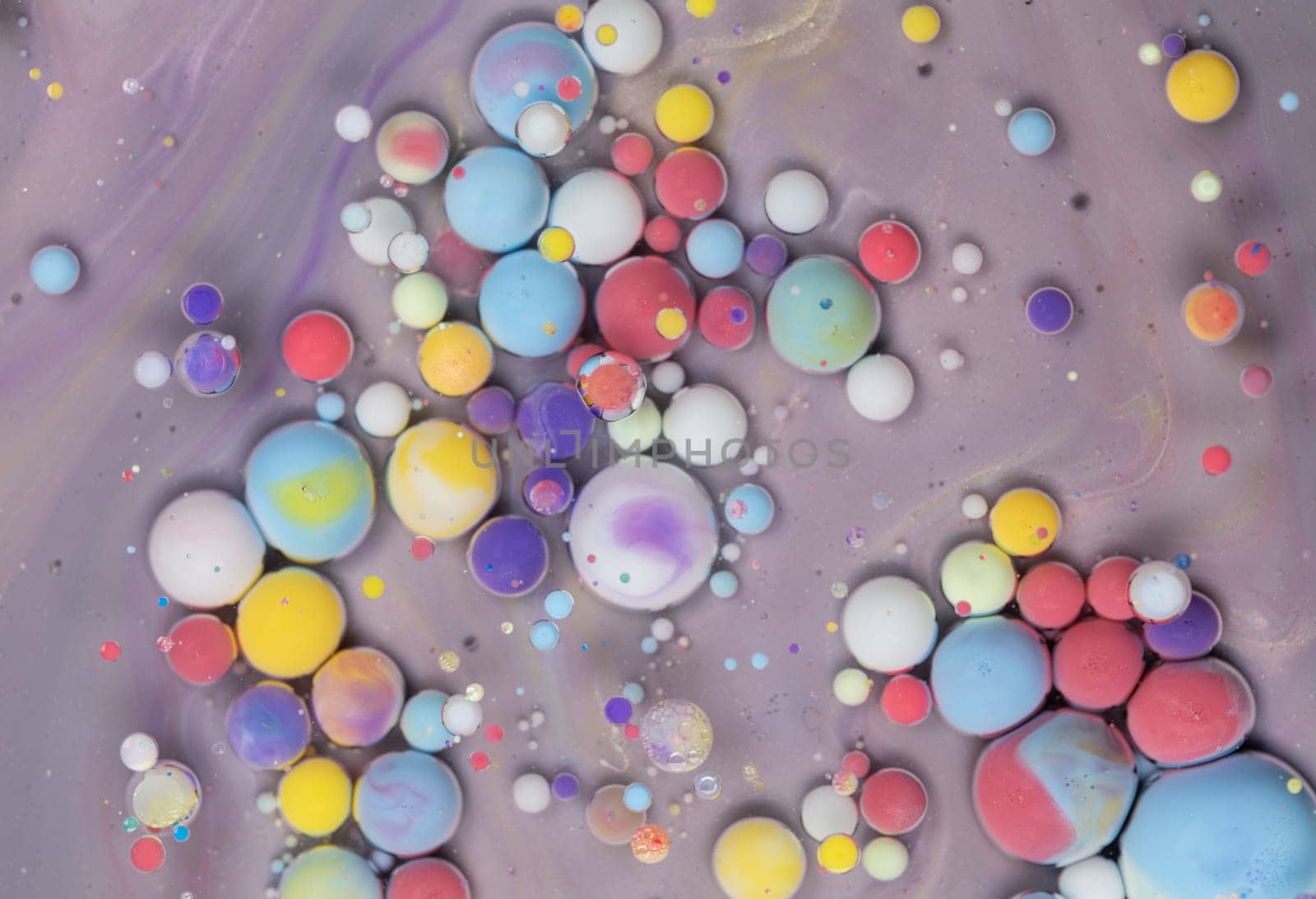 A Symphony of Spheres in Lavender HA close-up shot of vibrant, colorful spheres suspended in a lavender liquid, creating a mesmerizing abstract pattern.ues. High quality photo