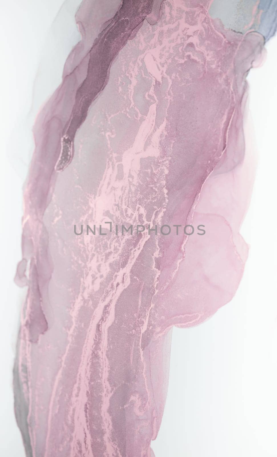 A close-up image of abstract pink and gray ink swirls on a white background. The ink creates a beautiful, flowing pattern.