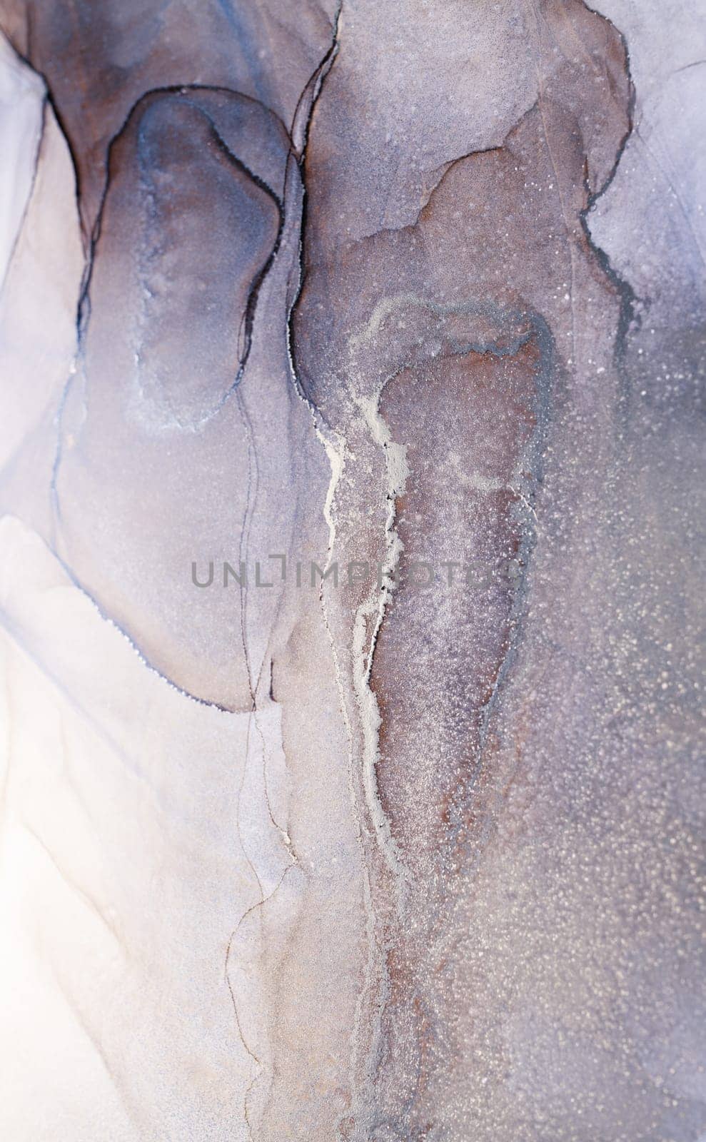 A close-up image of abstract ink art, showcasing swirling patterns in shades of silver and gray, resembling flowing water or clouds.