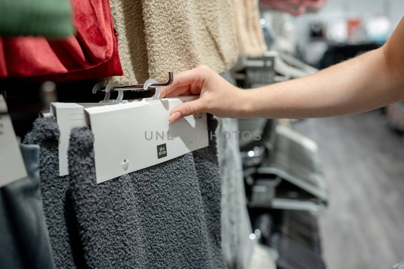 Young Girl In Store Chooses Pillowcase, Close-Up Of Hands