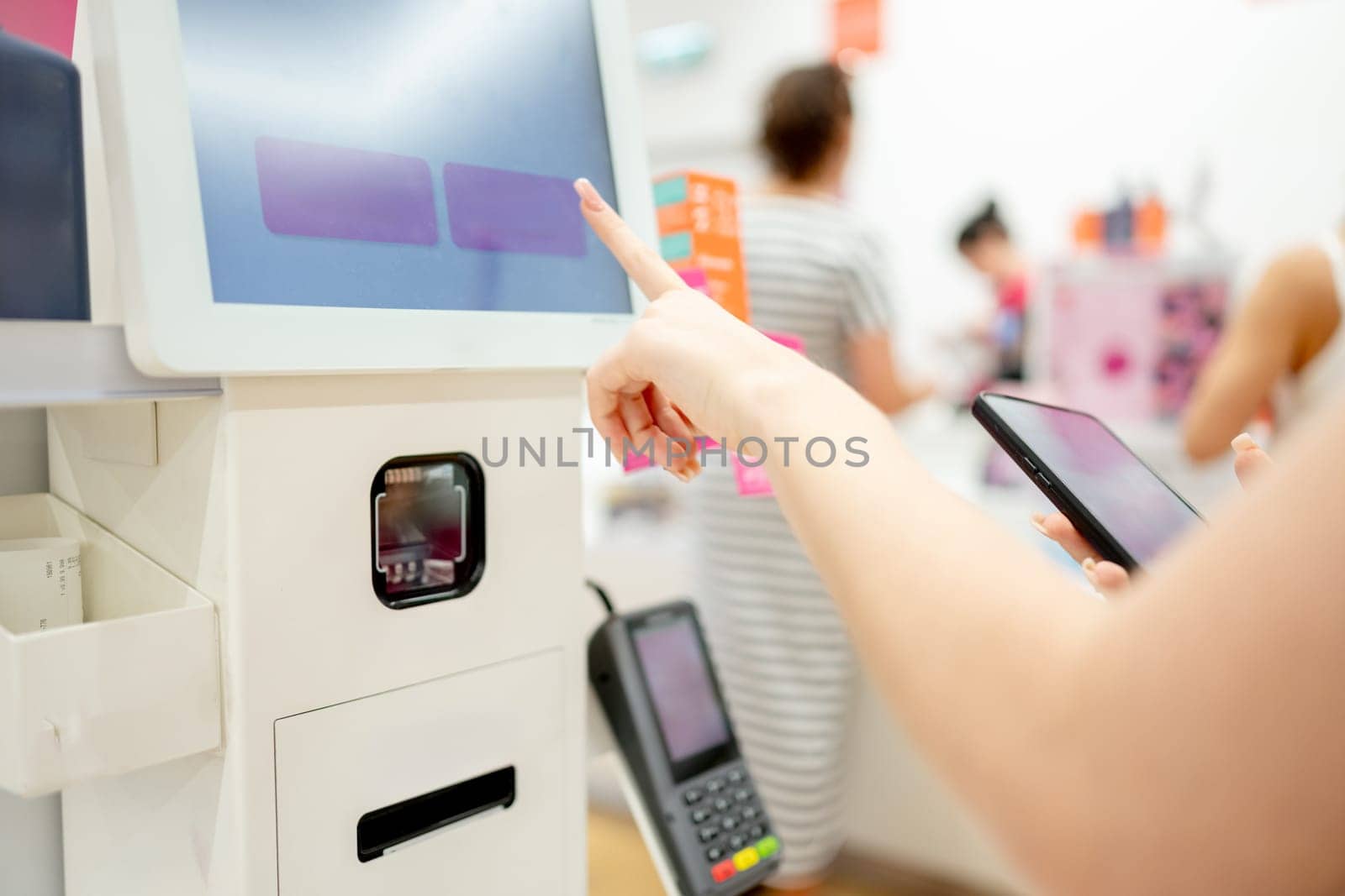 Girl Pays For Purchase At Self-Service Checkout, Close-Up Of Hands