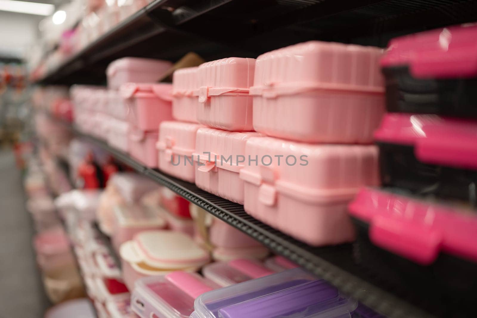 Pink Plastic Dishes Are On Display On A Store Shelf For Shopping