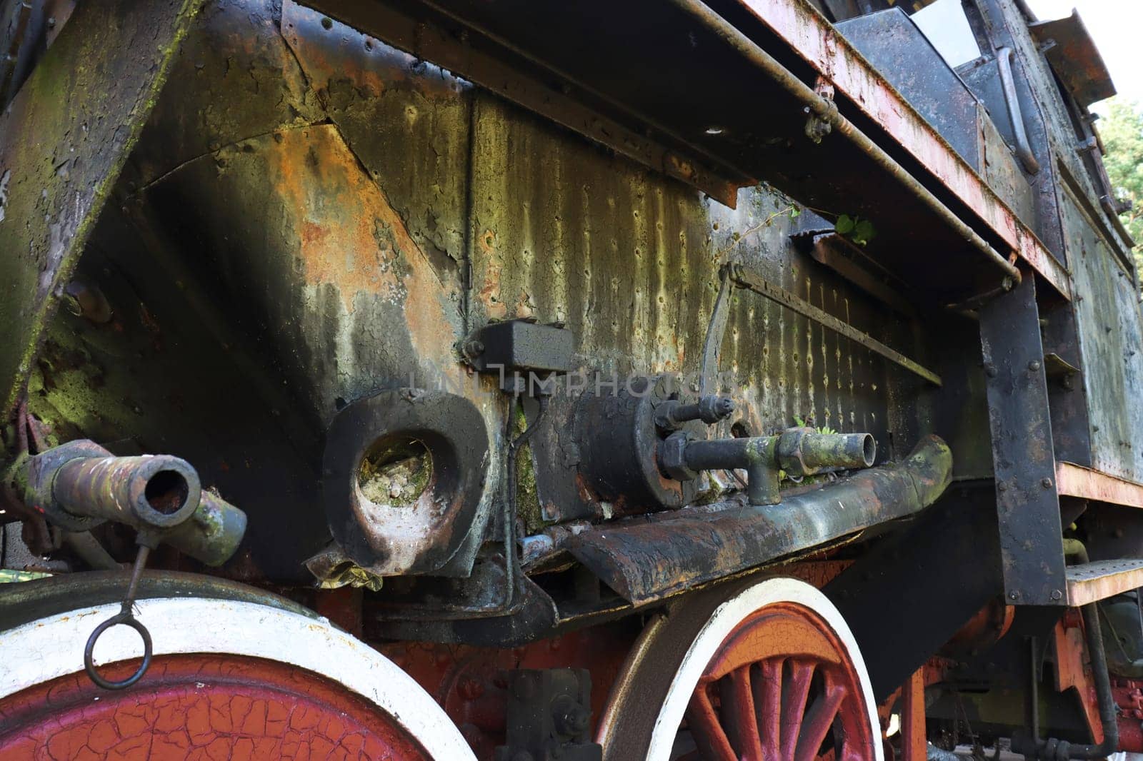 Chassis of an old steam locomotive. Chassis of an old steam locomotive...A fragment of the side and chassis of an abandoned retro locomotive.