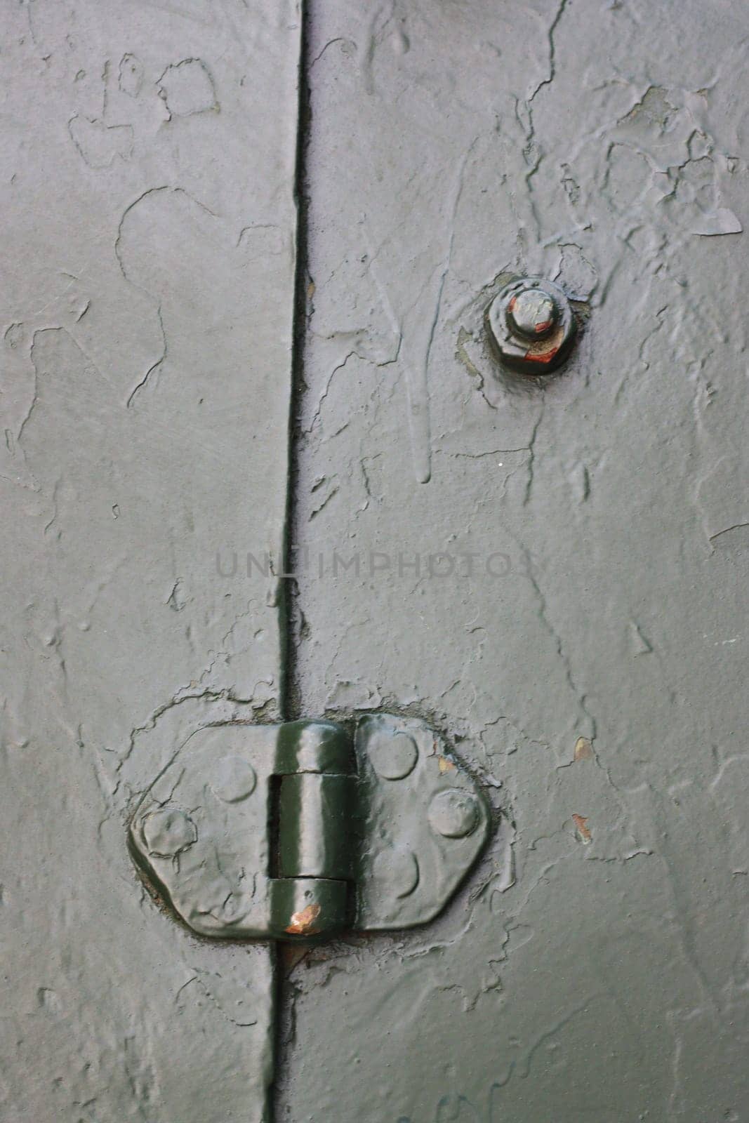 A close-up vertical photo of a fragment of a protective shield from an artillery gun.