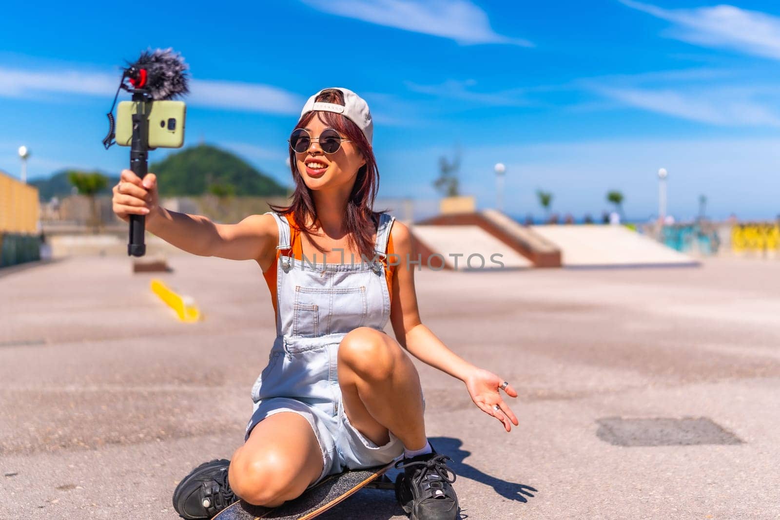 Chinese young female streamer vlogging online in a skate park