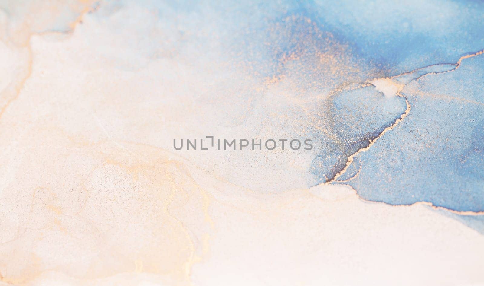 A close-up of abstract watercolor swirls in blue, gold, and white, creating a soft and ethereal effect.