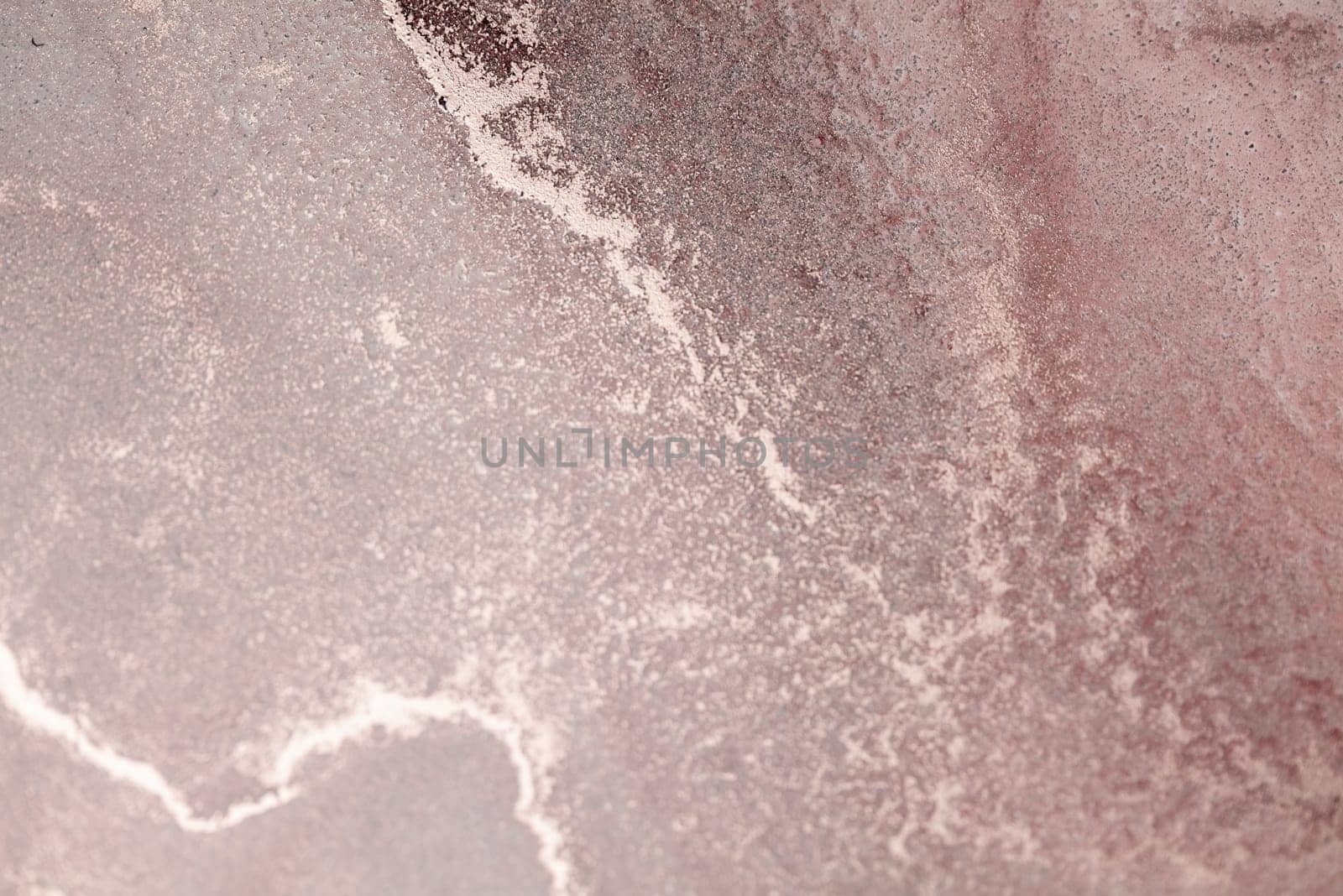 A close-up of a dusty rose sky at sunset with swirling clouds and glittering stars.