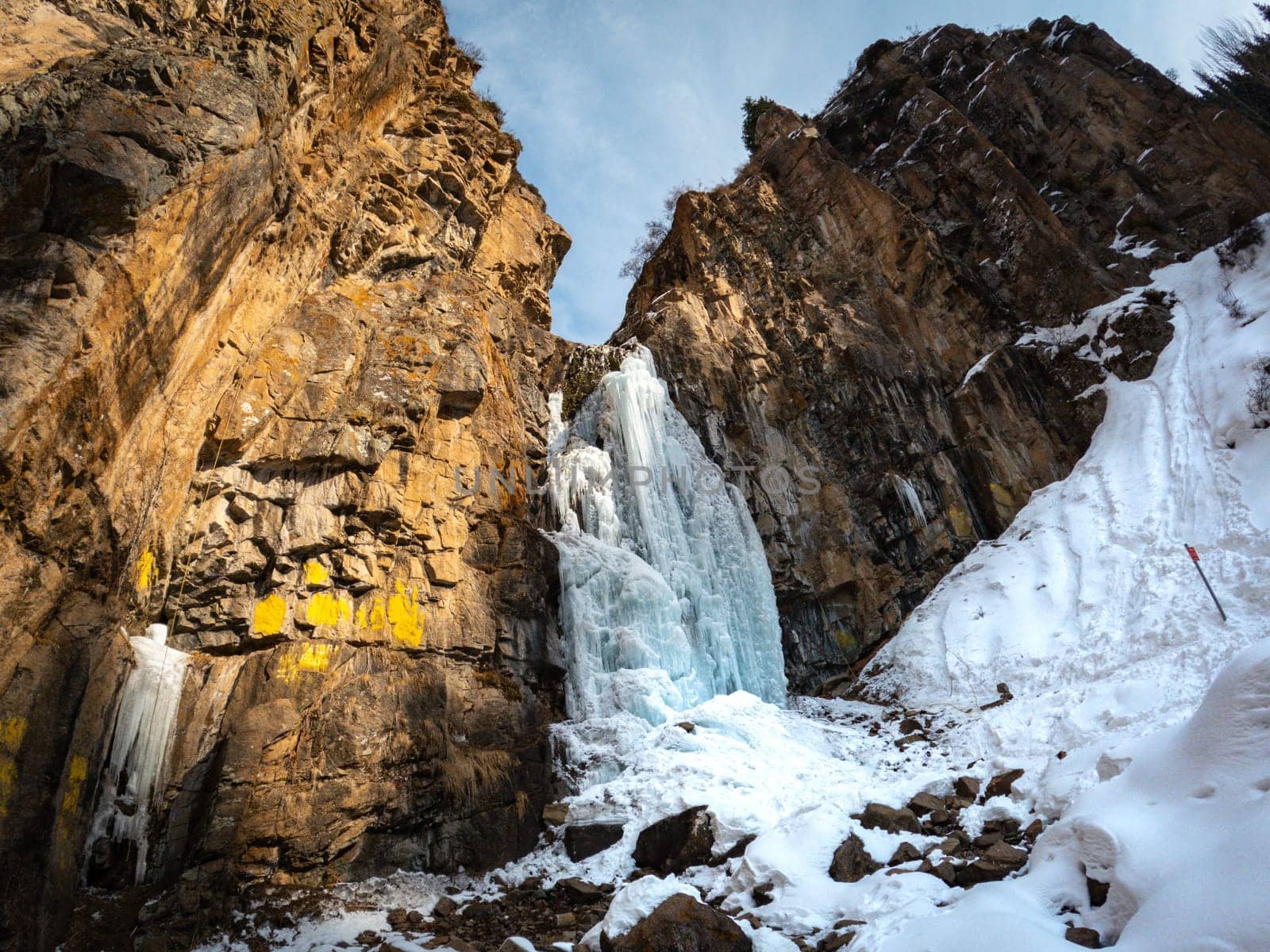 Scenic frozen Butakovsky waterfall in the Butakovsky gorge in the National Natural Park in the Tien Shan Mountains of Almaty in Kazakhstan.