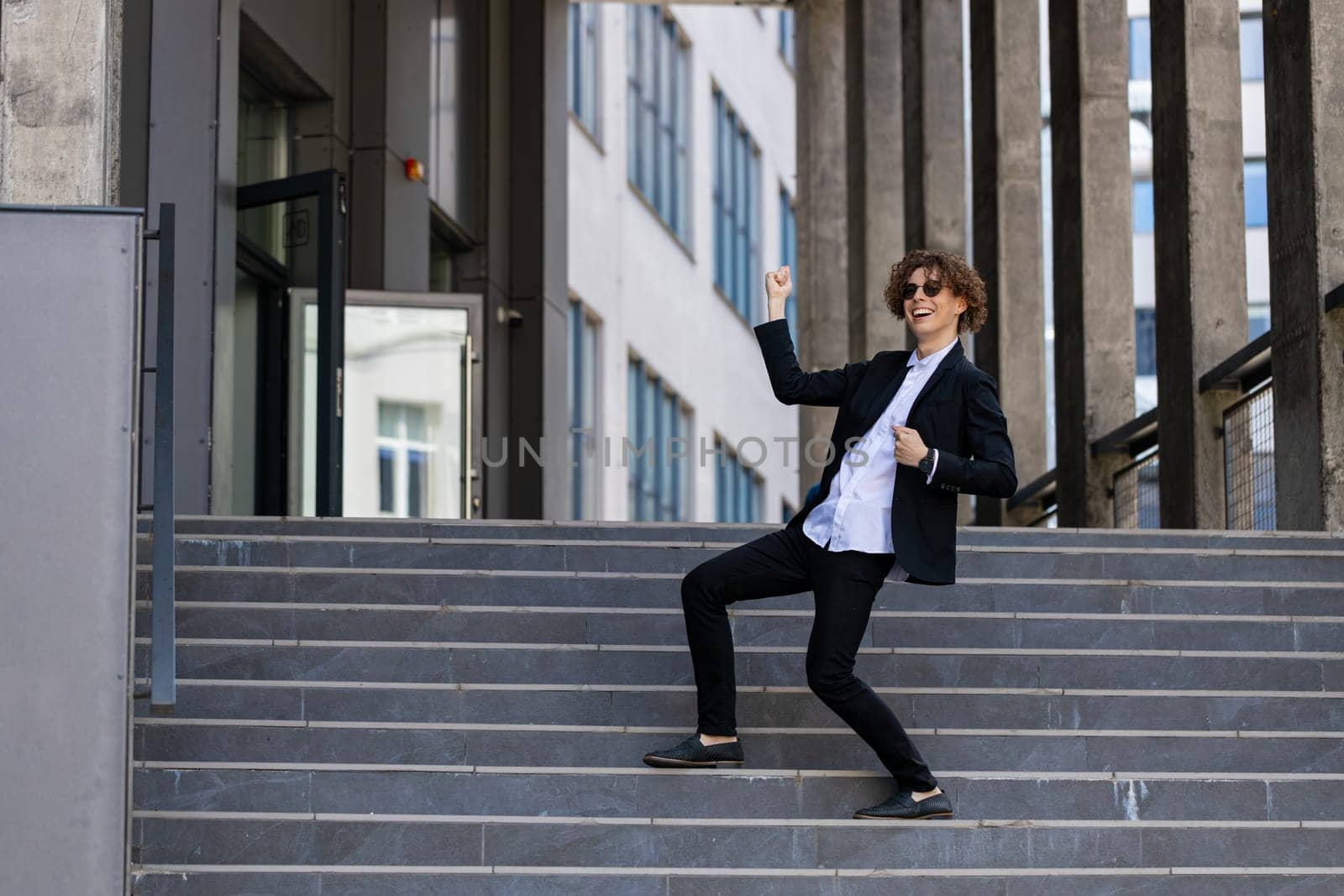 Dance, success or businessman in celebration at steps walking after a job interview, promotion or corporate deal. Excited, or happy dancing employee celebrates sales goals or target in downtown city.