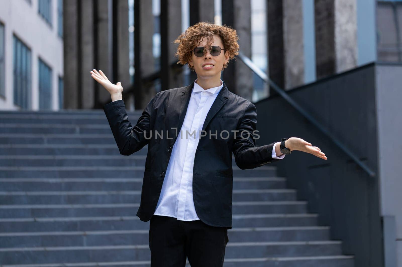 I don't know what to say. Confused business man standing outside office workplace. Young manager feeling embarrassed about ambiguous question, having doubts, no answer idea, being clueless, uncertain.