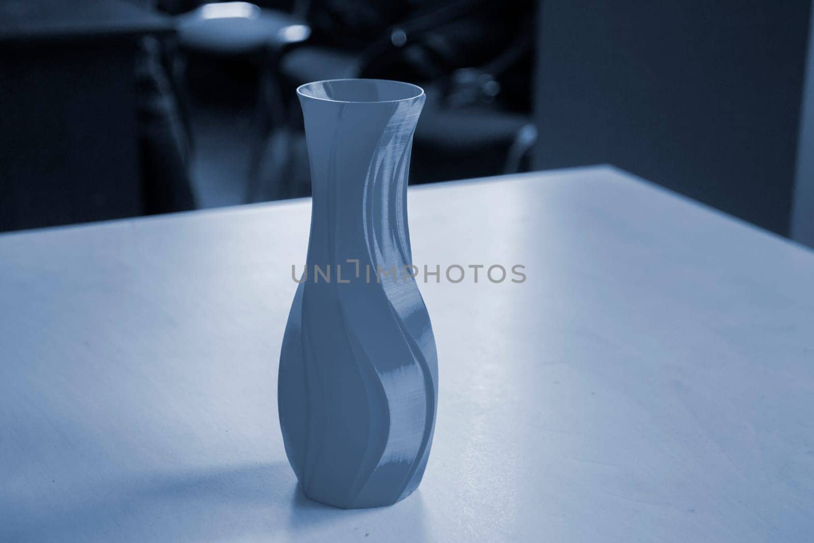 Object in the form of a vase printed on a 3D printer. Three-dimensional model printed on a 3D printer from molten plastic of red color. Concept 3D Printing. FDM 3D Printing technology