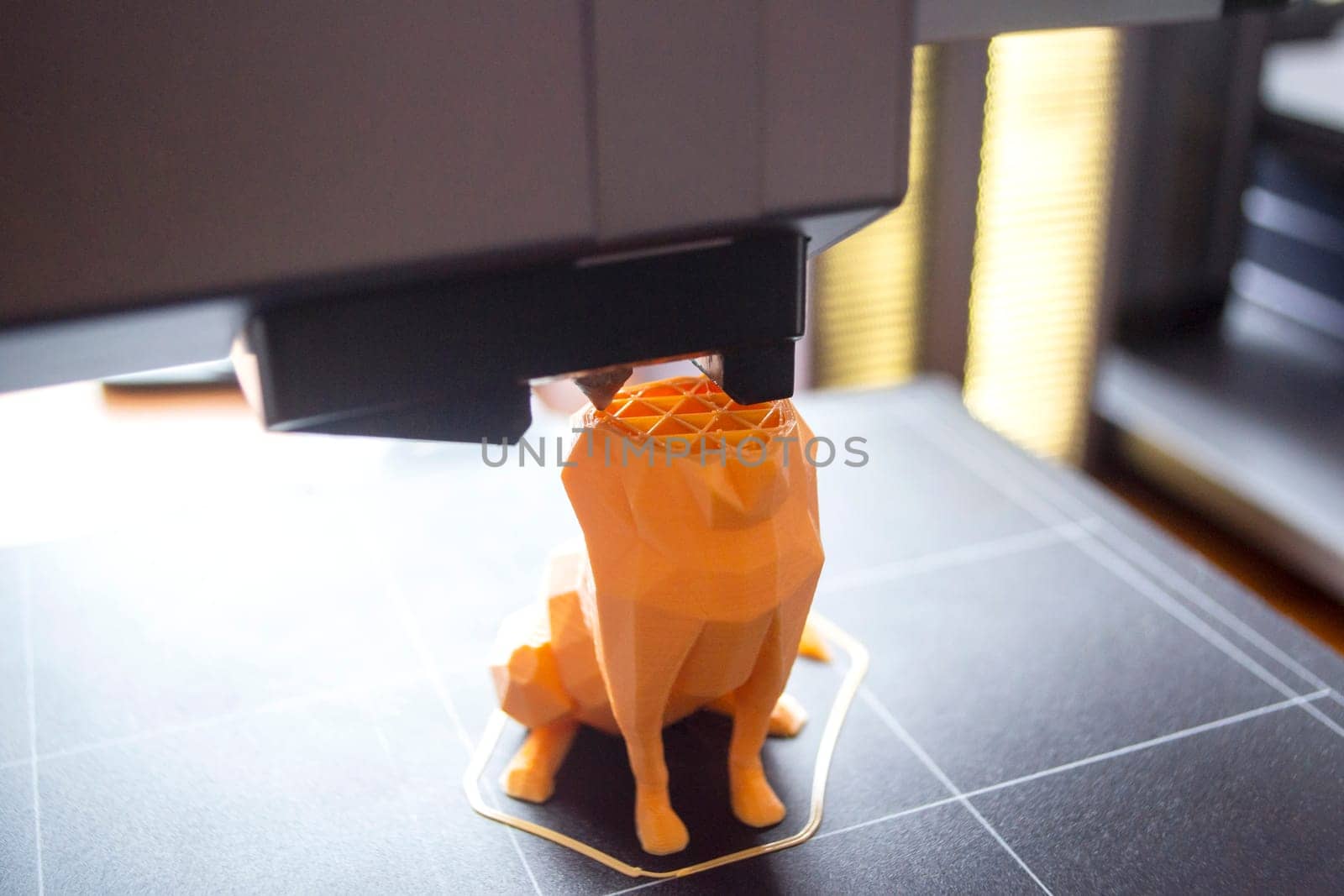 3D printer close-up. The process of working of 3D printer. 3D printer printing object from molten plastic. 3D printer creating model by flowing liquid plastic from an extruder. Printing technology