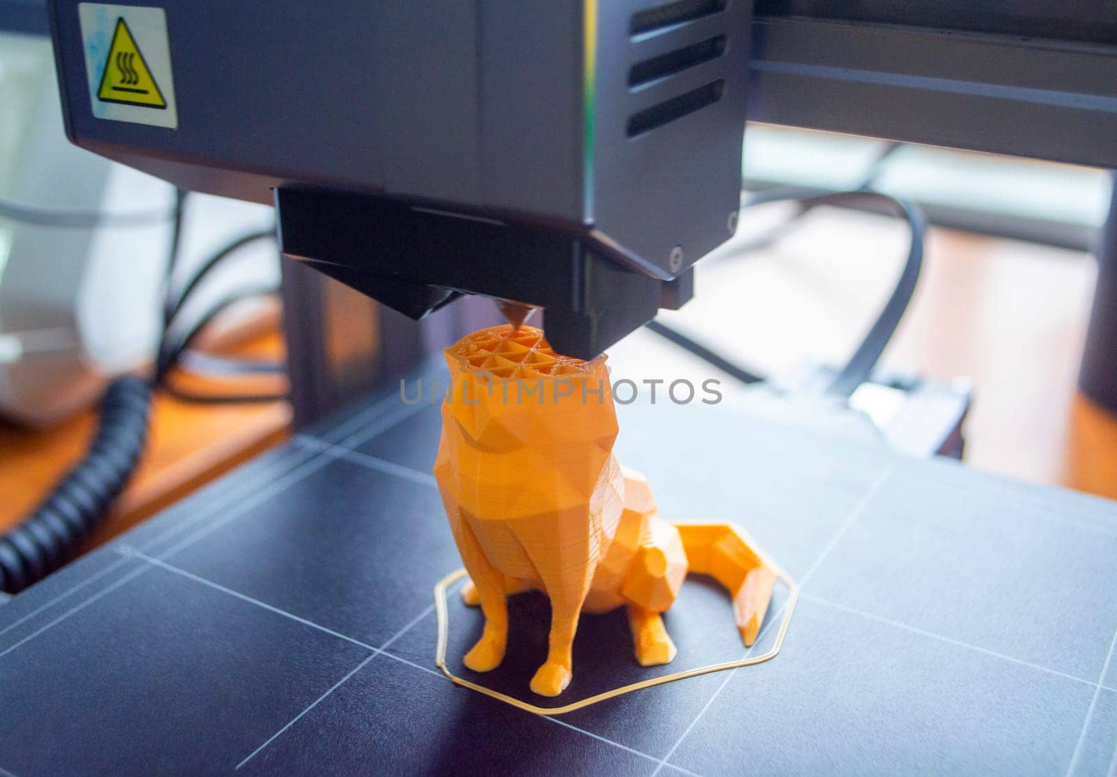3D printer close-up. The process of working of 3D printer. 3D printer printing object from molten plastic. 3D printer creating model by flowing liquid plastic from an extruder. Printing technology