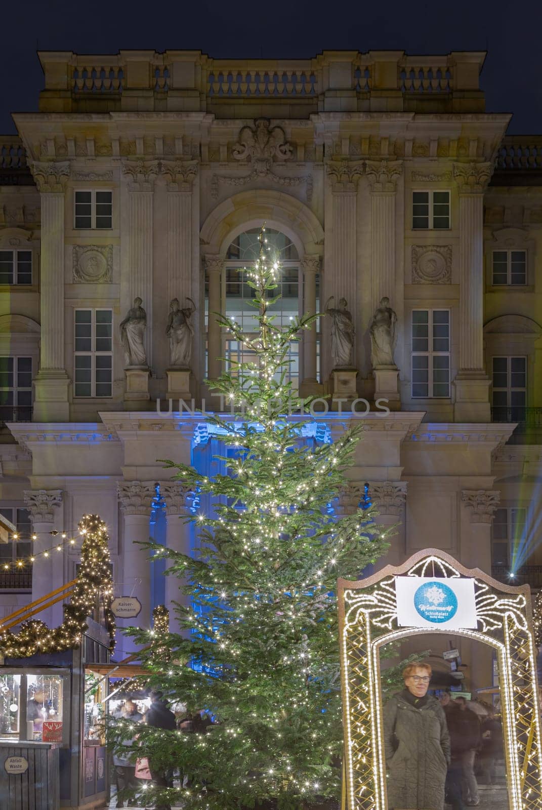 Berlin, Germany - Dec 19, 2023 - The Festive illumination of the palace facade at night. A Christmas market held in large courtyard of the restored Berlin Palace (Berliner Schloss) also known as Humboldt Forum Located on Schlossplatz. Copy space, Selective focus.