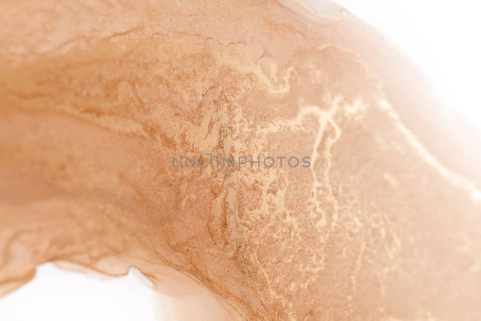 A close-up of a peach and gold abstract swirl pattern, which appears to be a liquid or paint mixture.