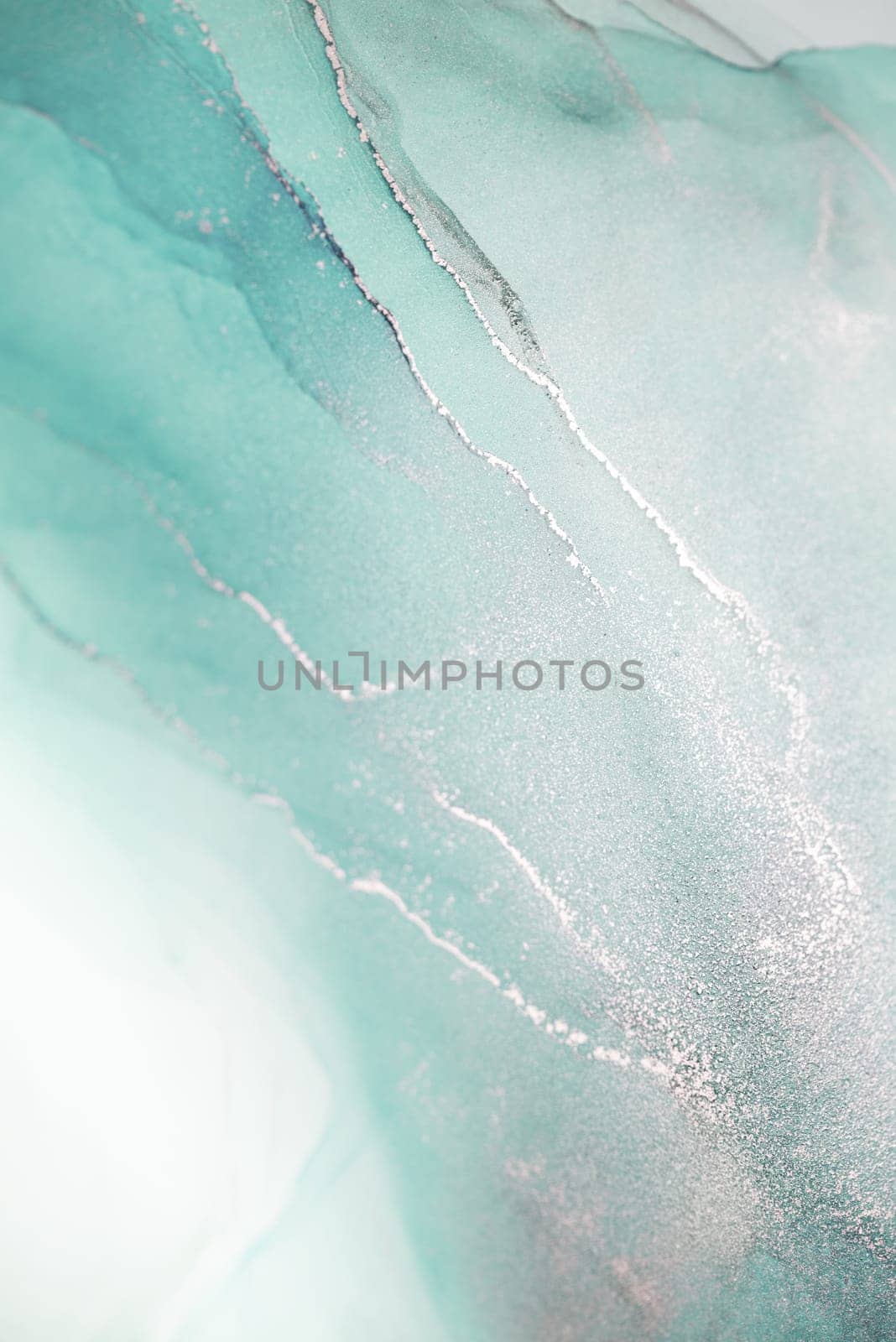 A close-up abstract art piece featuring swirling mint green and white hues with delicate silver streaks running through it.