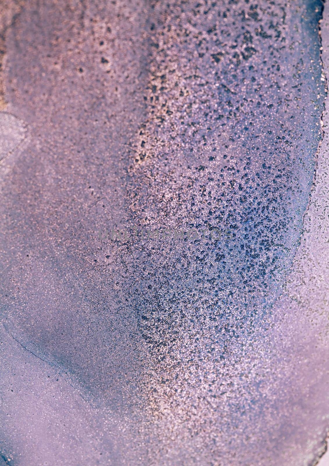 A close-up image of a purple and blue ink swirl, showcasing a textured, abstract pattern.