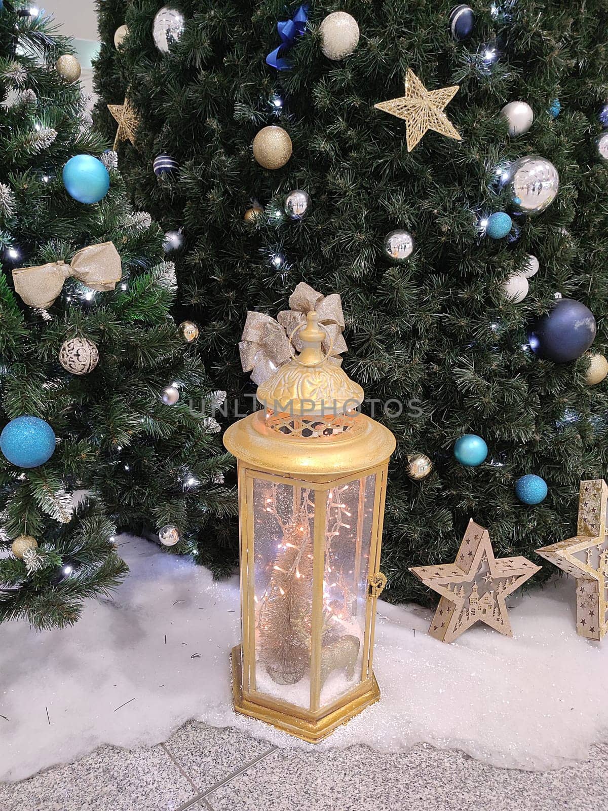 decorated Christmas tree and festive decorative lantern close-up.