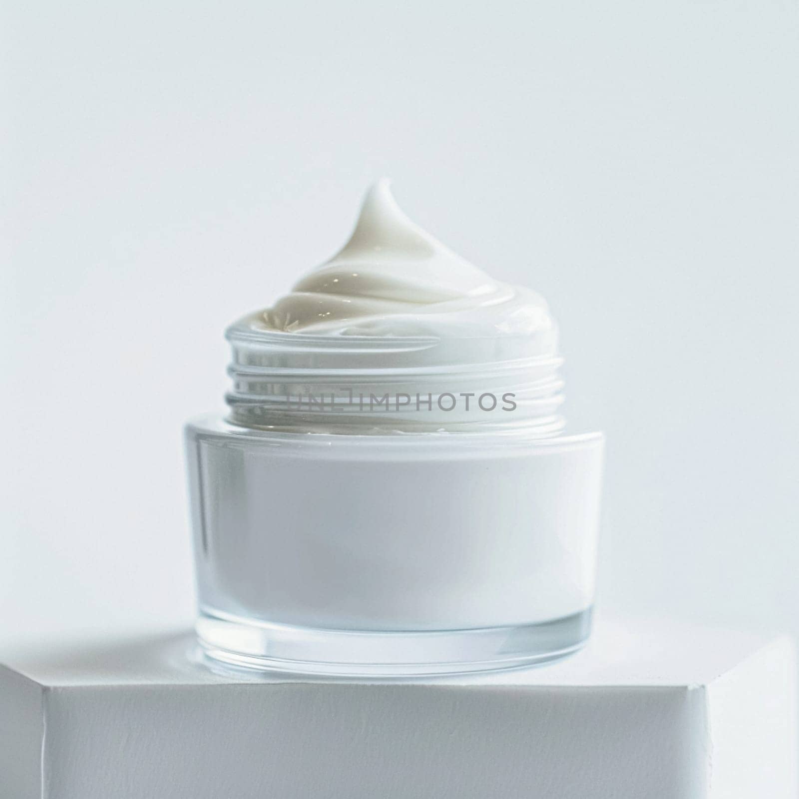 Face cream in a glass jar on a white and gold background. Skin care concept. Backdrop for beauty cosmetic products
