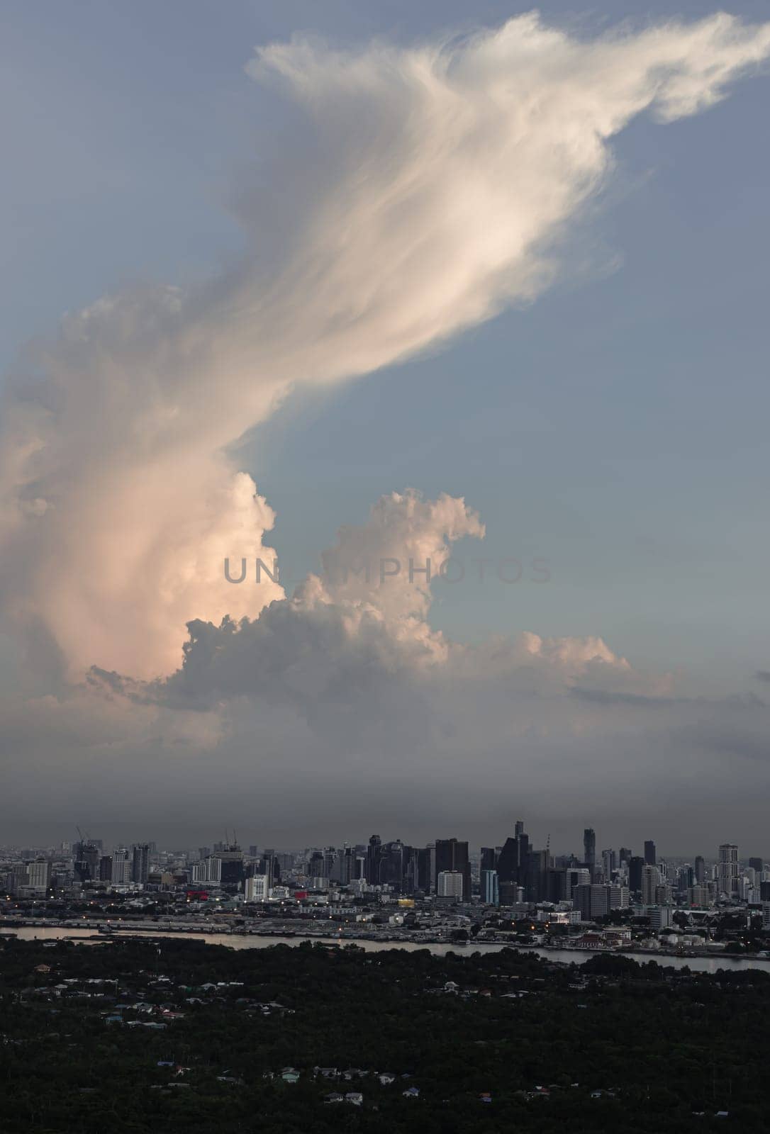 Bangkok, Thailand - 28 May 2024 - Aerial view of skyscrapers and dramatic sky before sunset. Beautiful clouds in the sky over large metropolitan city of bangkok, Space for text, Selective focus.