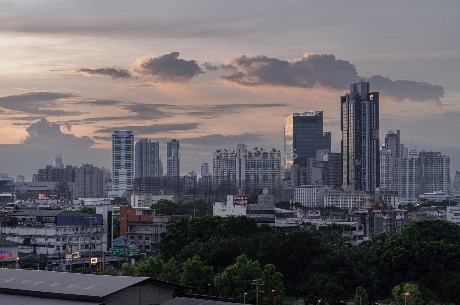 Bangkok, Thailand - 29 May 2024 - Beautiful Clouds in the Sky over Large Metropolitan City of Bangkok. View of Skyscrapers and Dramatic Sky before Sunset, Space for text, Selective focus.