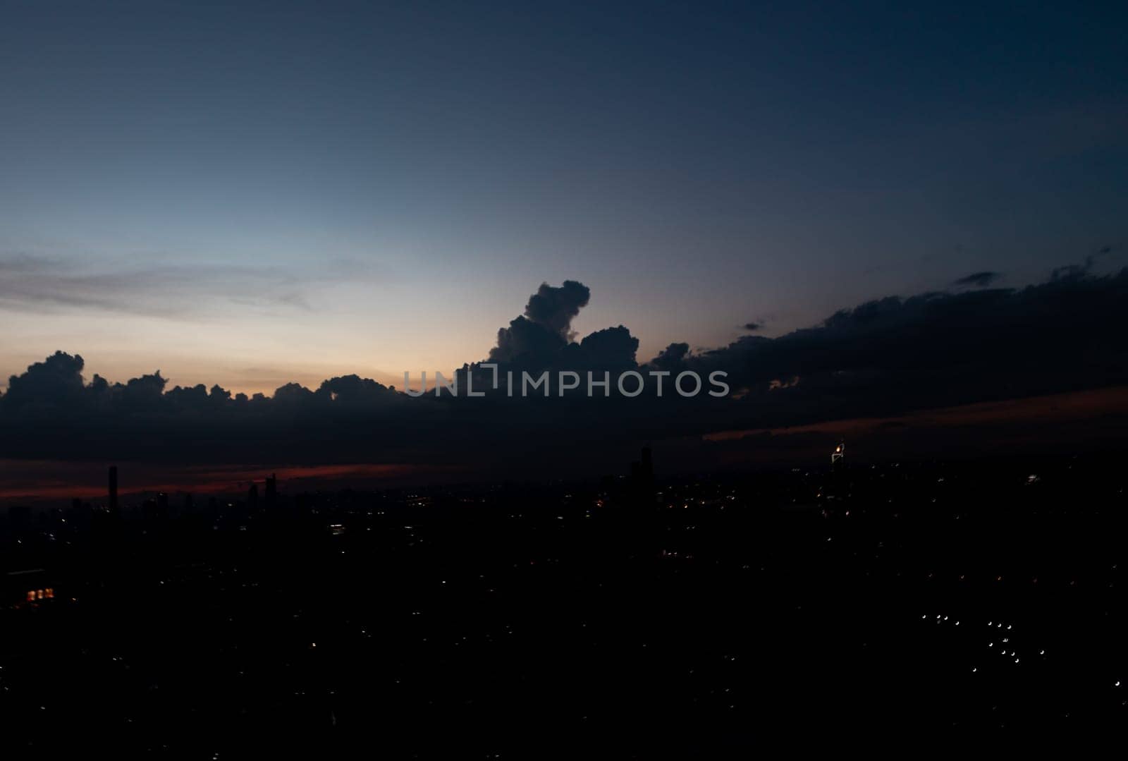 Bangkok, Thailand - 15 Jun, 2024 - Silhouette of skyline view. Twilight sky in the Evening with dark clouds on silhouette of the city, Natural atmosphere night sky, Copy space, Selective focus.