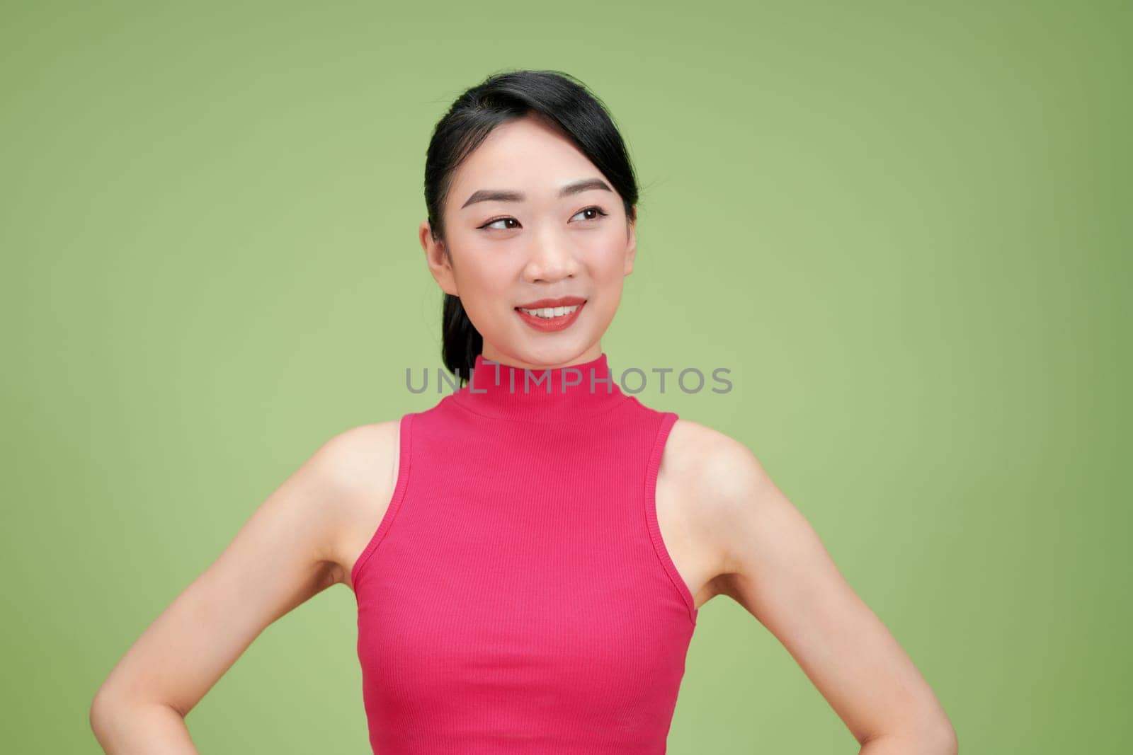 Close up portrait of young happy woman on green background