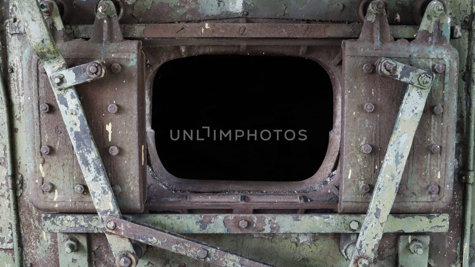 Broken locomotive firebox door. A close-up fragment of the open firebox in the engine of an abandoned retro locomotive.