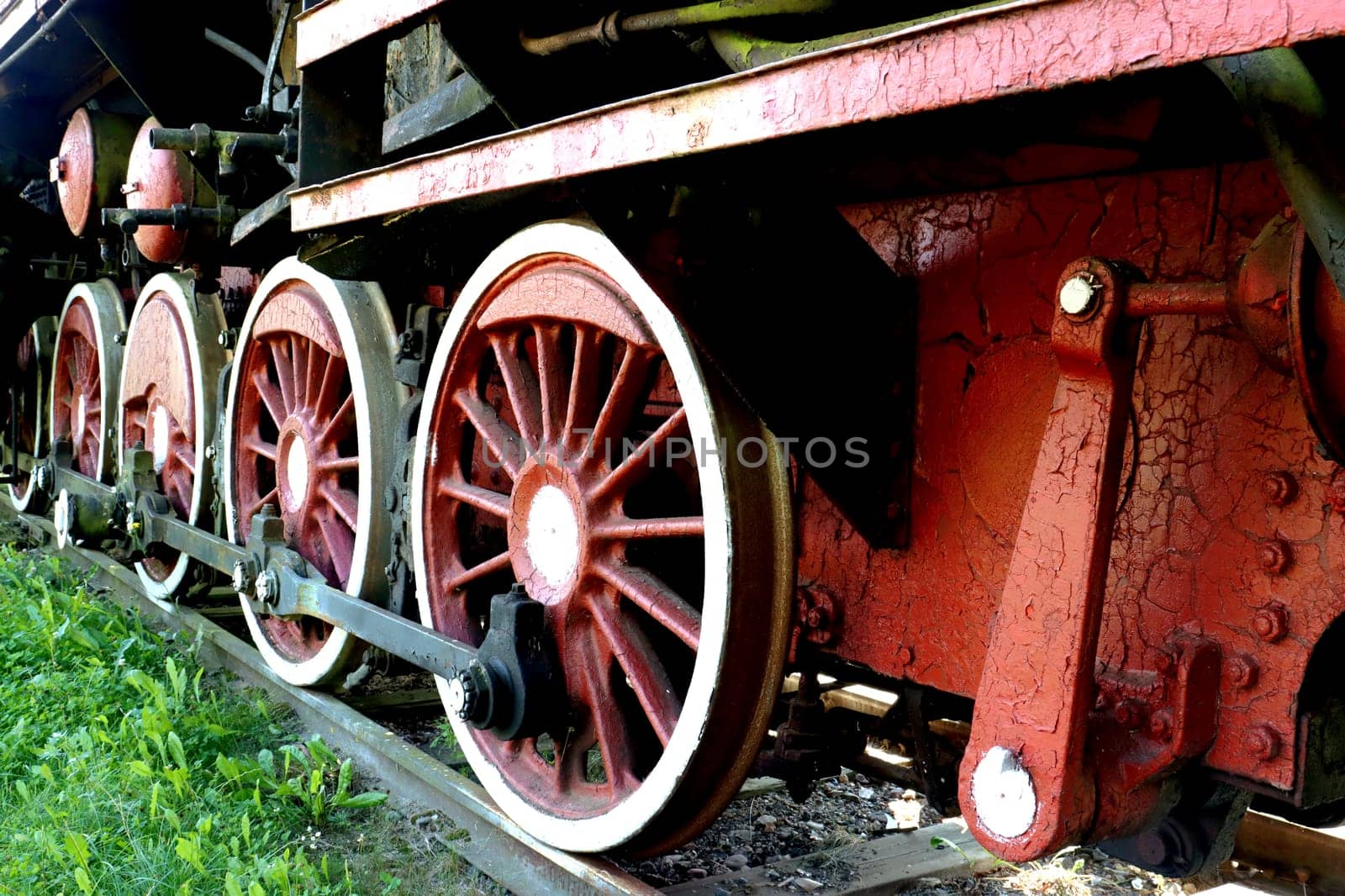 Parts, elements of mechanical parts, wheels and train equipment. Chassis of an old steam locomotive. Detail of one wheel of a vintage steam train locomotive
