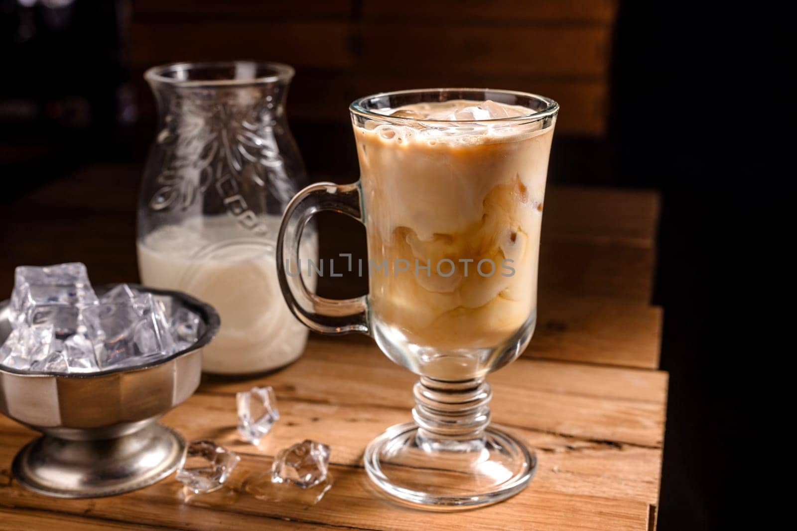 coffee drink with cream and ice on a dark wooden background, cold tonic drink coffee