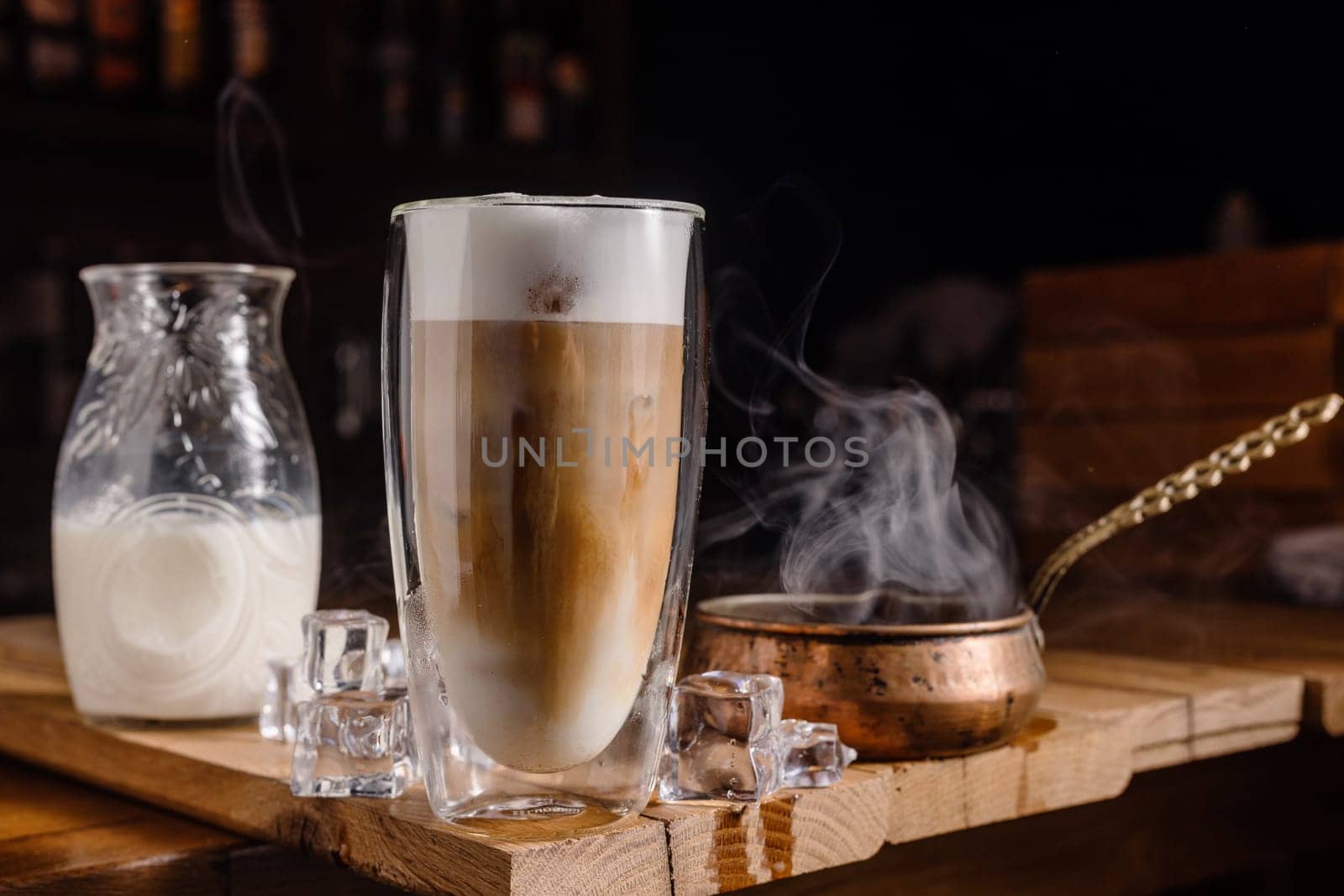 coffee drink with cream and ice on a dark wooden background, cold tonic drink coffee
