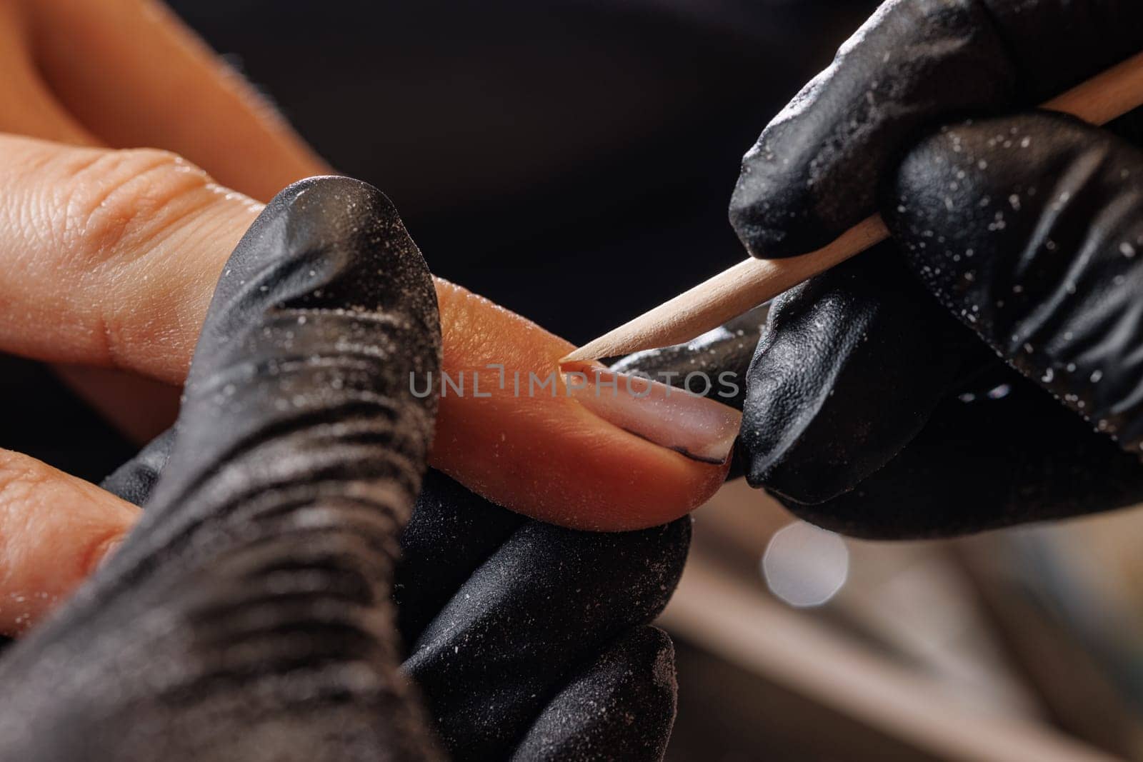 A manicurist gives a hardware manicure to a client using special tools. nail salon, self care concept