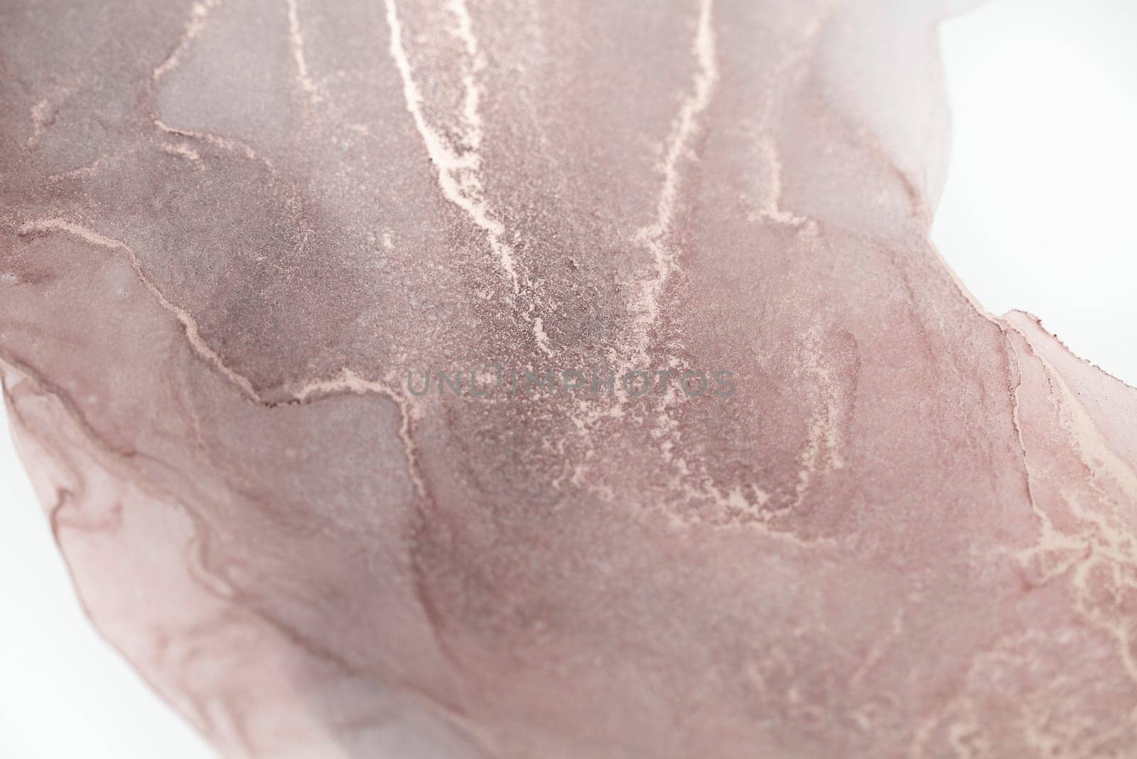 A close-up of an abstract painting with swirling patterns of rose gold ink on a white background.