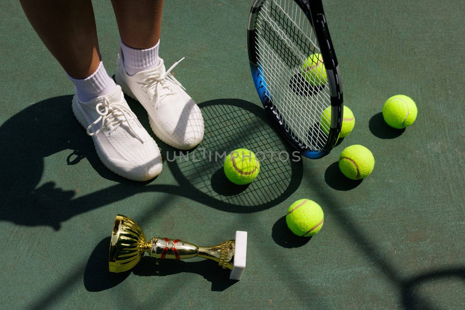 young female tennis player celebrating victory on the court, close-up of cup and tennis racket, victory in tennis tournament