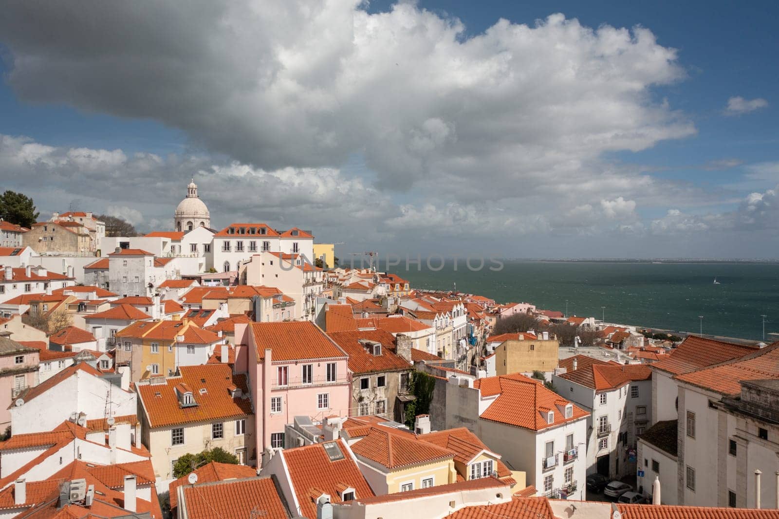 Aerial drone Lisbon historic downtown. Drone 4k of cityscape capital of Portugal. Alfama district. Summer in Europe travel, famous tourism destination