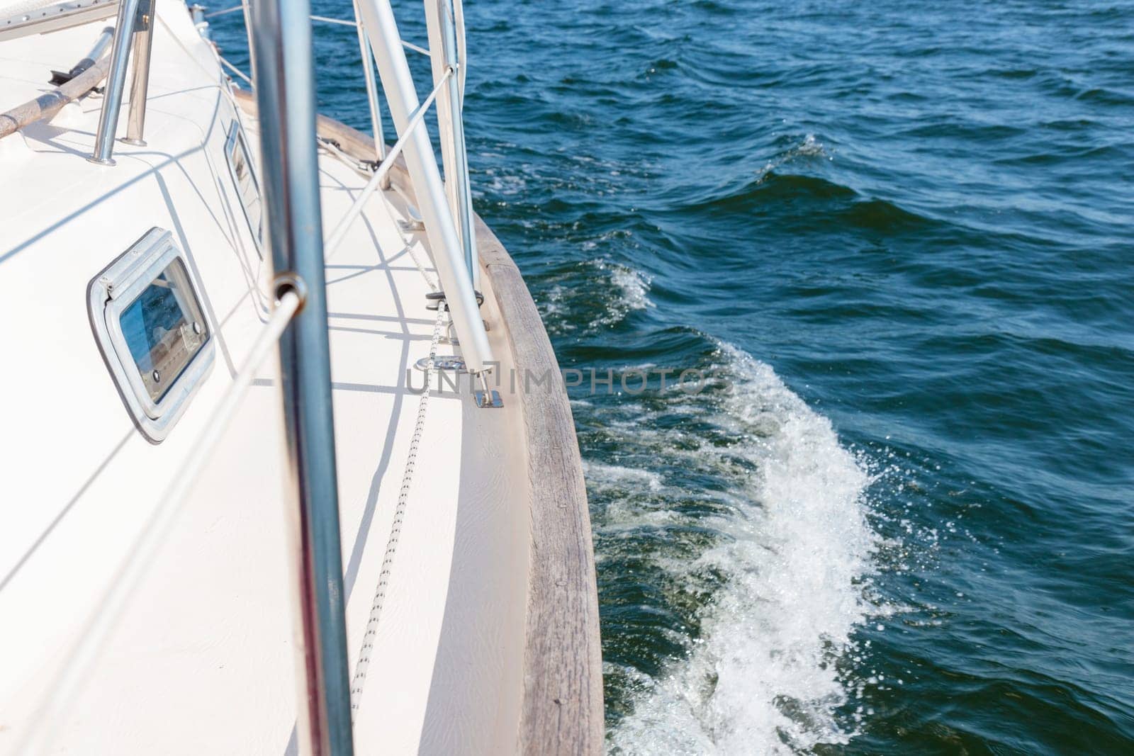 Banner with sailing in an open sea with waves. View to the side deck. Classic sailboat. Summer adventure, recreation, cruise, vacations, regatta, sport in Finland, Gulf of Finland.