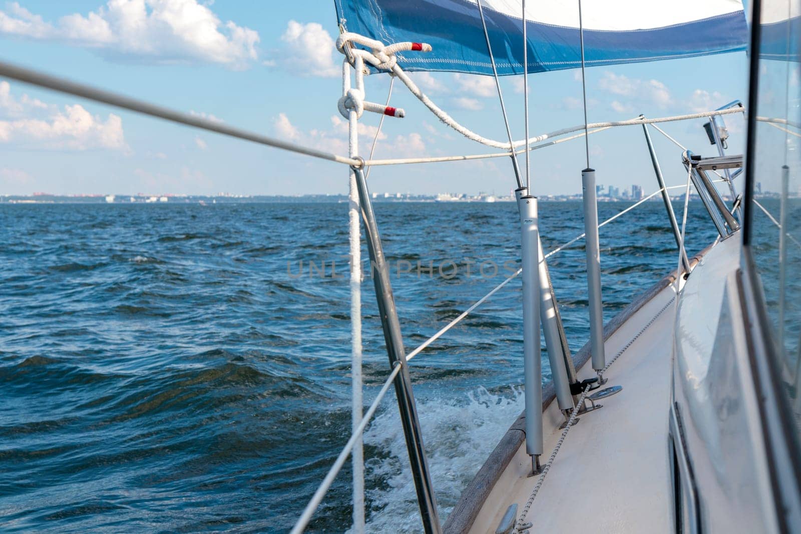Turnbuckle aluminum covers on a classic sailboat on the side deck. Summer adventure, open sea with waves, recreation, cruise, vacations, regatta, sport in Finland, Gulf of Finland.