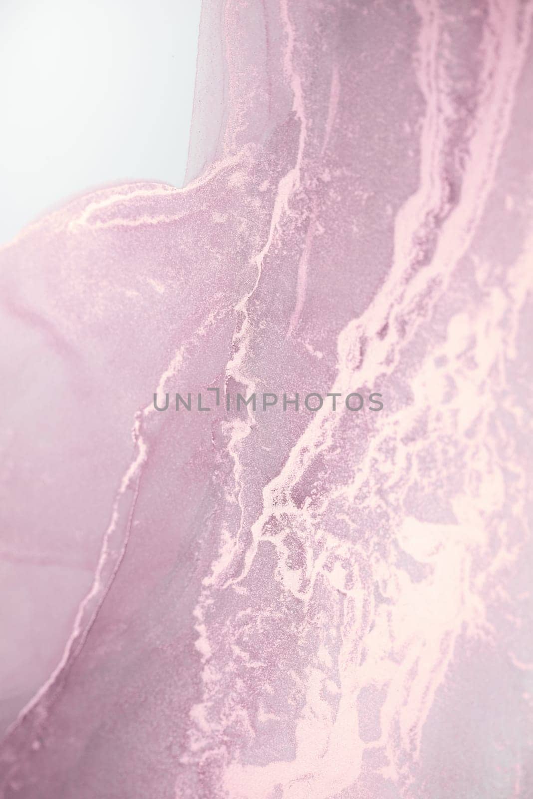 A close-up photograph of a swirling, abstract pattern in soft pink and white hues.