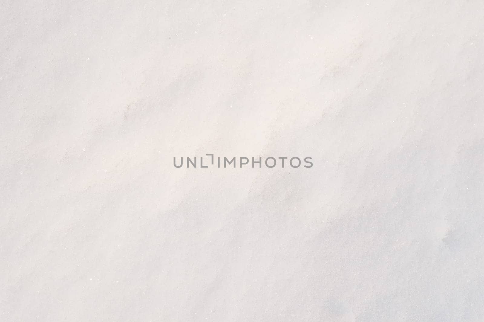 Snow surface close-up in sunny weather. Snow texture close-up.
